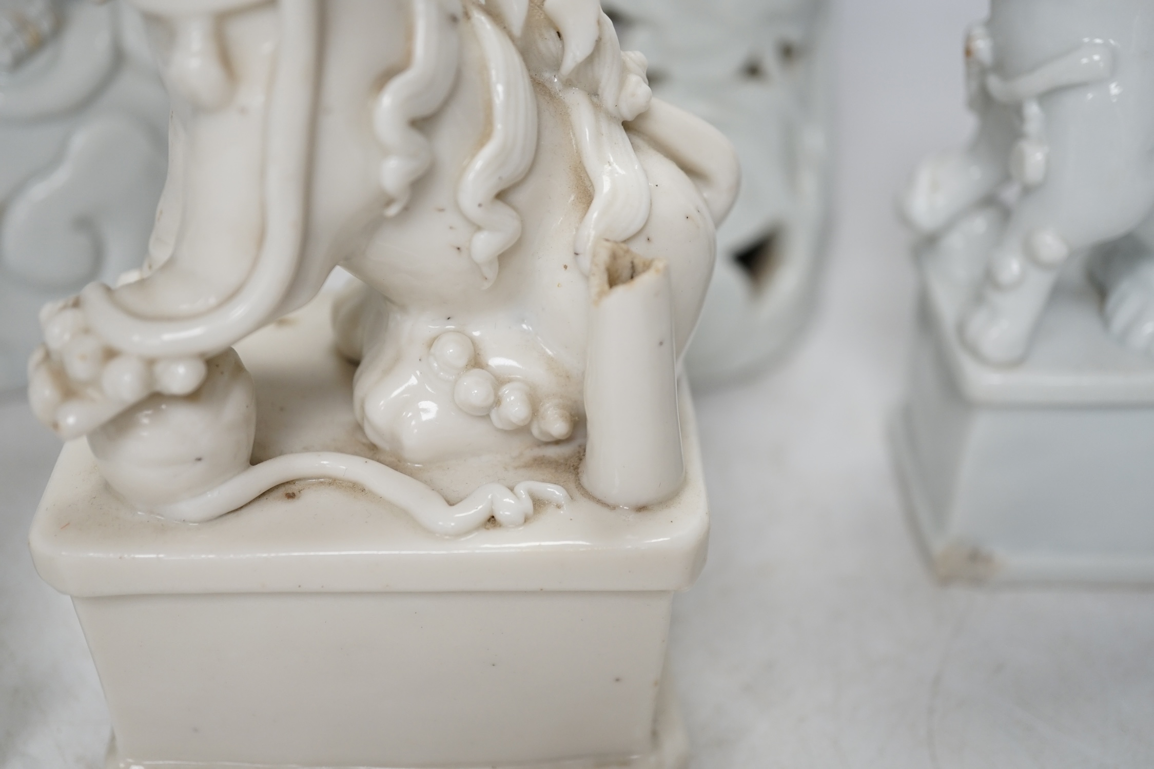Seven Chinese blanc de chine pieces to include a pair of lion dogs and a phoenix, 17th century and later, largest 44cm high. Condition - varies, poor to fair